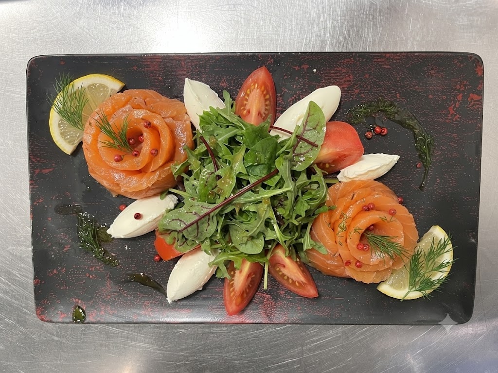 Assiette de saumon gravlax en roses de saumon, crème et citron
